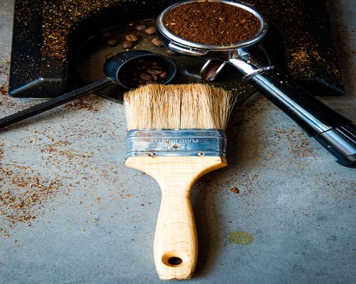 Person preparing morning coffee in a modern kitchen